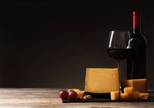 Delicious Cheese Served With Red Wine On Table Against Dark Background. Space For Text