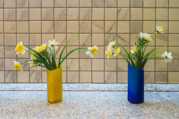 decorative flowers in two vases on the table