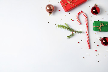 Flat lay composition with Christmas gifts and festive decor on white background. Space for text