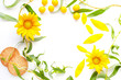mockup copyspace from flowers of a sunflower and greens on a white background flat lay