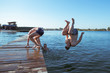 © phpetrunina14 - friends jumping from wooden pier in water