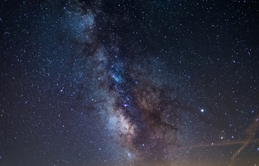Wall Mural - milky way galaxy core and jupiter planet glowing in a bright starry night sky. christmas background,