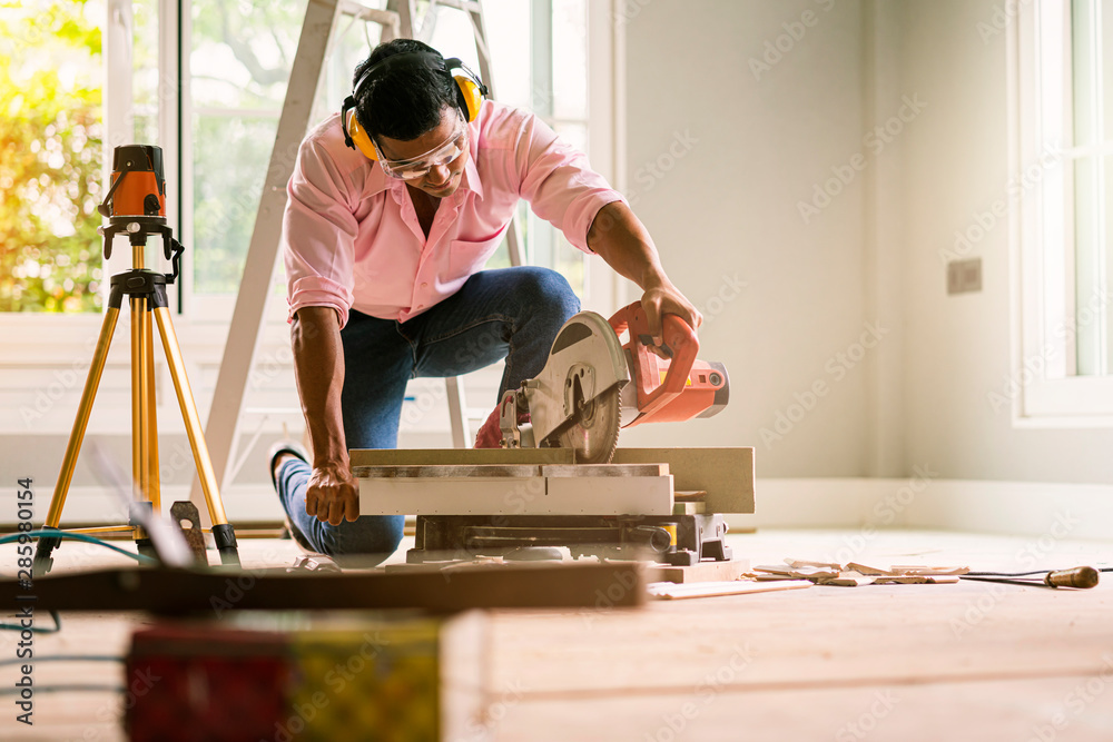smart indian contractor hand use sawing machine wood work house renovation background home improvement ideas concept - obrazy, fototapety, plakaty 