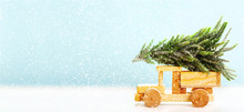 Christmas Background. Wooden Car Carrying Christmas Tree On A Snowy Landscape