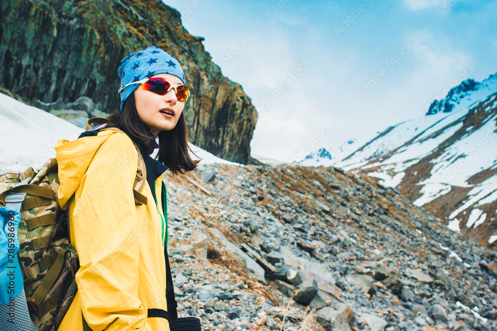Traveling girl with backpack hiking in the mountains, freedom concept ...
