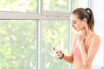 Sticker - Sporty young woman checking her pulse after training in gym