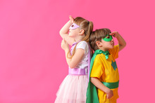 Cute Little Children Dressed As Superheroes On Color Background