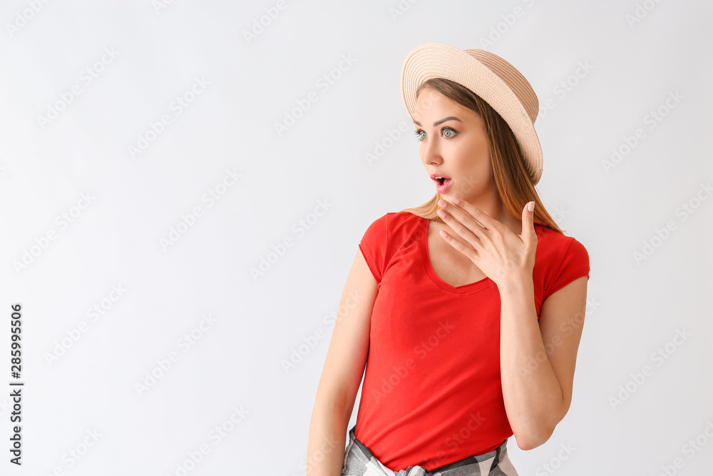 Surprised young woman on white background