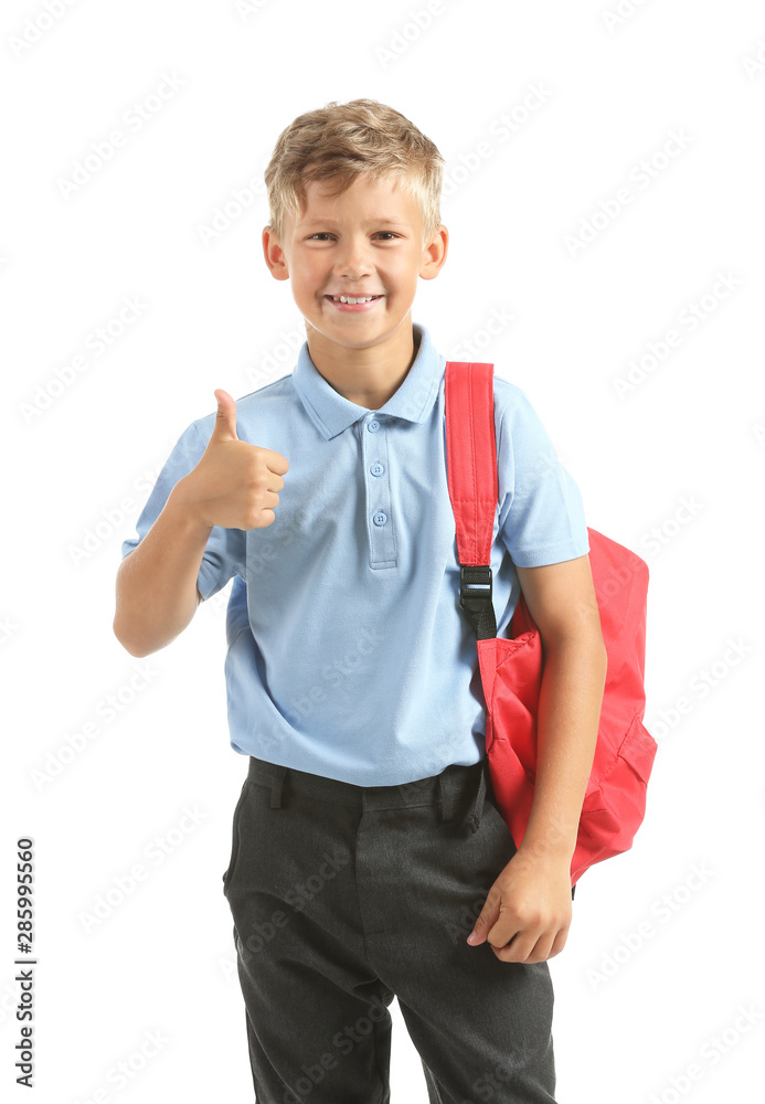 Little schoolboy showing thumb-up on white background