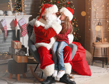 Santa Claus And Little Girl In Room Decorated For Christmas