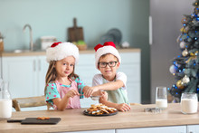 Cute Little Children Preparing Christmas Cookies At Home