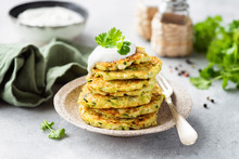 Vegetarian Zucchini Fritters Or Pancakes Stack Topped With Sour Cream And Cilantro. Vegetable Pancakes