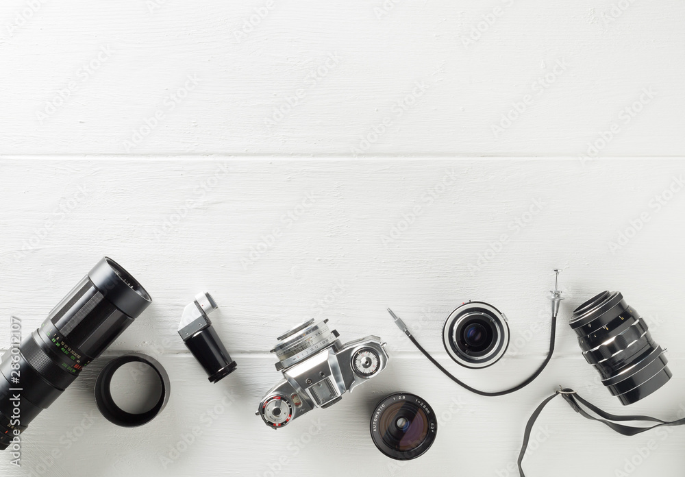 Retro analog film camera with lenses and photography equipment on white wooden background with copy space - photography or creativity concept, flat lay top view from above - obrazy, fototapety, plakaty 