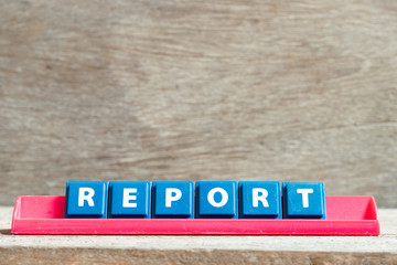 Sticker - Tile letter on red rack in word report on wood background