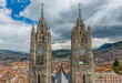 Cityscape of Quito and its historic city center located in the Andes mountain range with a view over the Basilica of the National Vow in Neo Gothic style, Quito, Ecuador, South America.