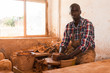 © JackF - Man focused on work on pottery wheel