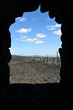 View of lava fields and volcanoes framed in windows of Dee Wright Observatory at summit of McKenzie Pass in Cascade Mountains, Oregon.