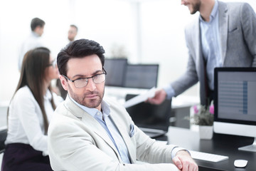 Wall Mural - businessman sitting at the office Desk