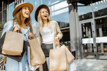 Portrait Of A Two Happy Women With Shopping Bags, Standing Together In Front Of The Shopping Mall