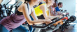 © Kzenon - Asian woman and her friends on fitness bike in gym