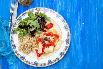 cod fish with quinoa and fresh salad on dish