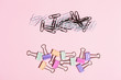 © paninastock - Different bright paper clip pattern on pink background.