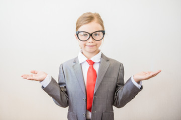 Smiling child girl opened her hands in the shape of scales on white background. Success, creative and innovation business concept