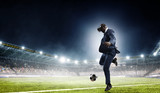 Fototapeta  - Black businessman on virtual reality football match