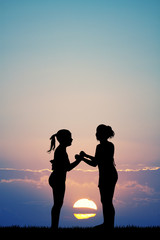 Wall Mural - sisters at sunset