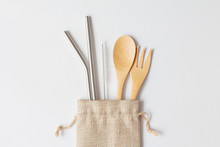 Flat Lay Of Reusable Stainless Steel Straw With Wooden Spoon In Natural Sack Bag On White Background, Eco Friendly And Zero Waste Concept.