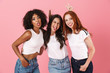 © Drobot Dean - Happy cute funny multi-ethnic girls friends posing isolated over pink wall background.