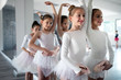 © NDABCREATIVITY - Group of little ballerinas girls doing exercises in dance school