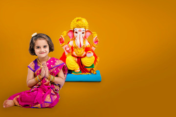 Little indian girl with lord ganesha, Indian ganesh festival