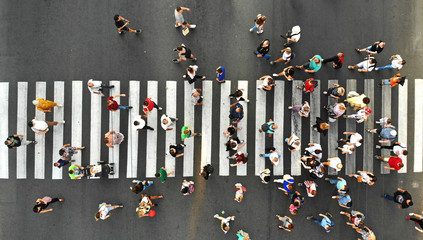 aerial. people crowd. many people going through the pedestrian crosswalk. top view.