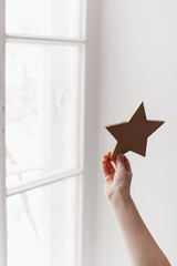star in the hand of a child against the window
