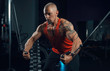 © rotozey - strong muscular man trains in the gym