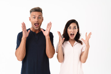 Wall Mural - Excited attractive couple wearing casual outfit standing