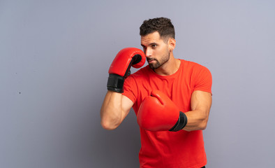 Wall Mural - Young sport man with boxing gloves