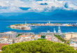 Beautiful panorama of Messina port with blue mountains in the background. It is written on the seawall in Latin 