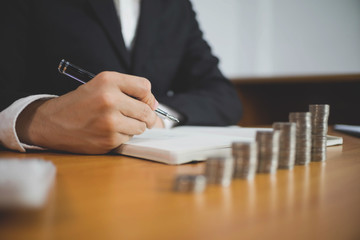 Businessman working with income statement document on the wood table.Business concept.