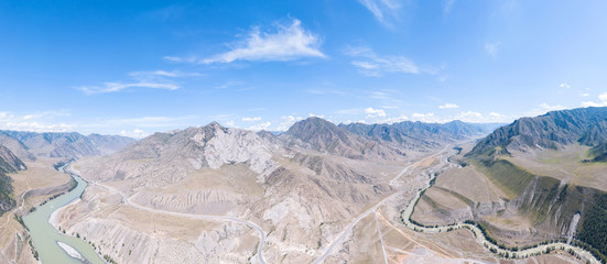 panoramic aerial view nature and picturesque landscapes near a mountain with a river and green trees on a summer day with blue sky.Altay river katun and chuya.