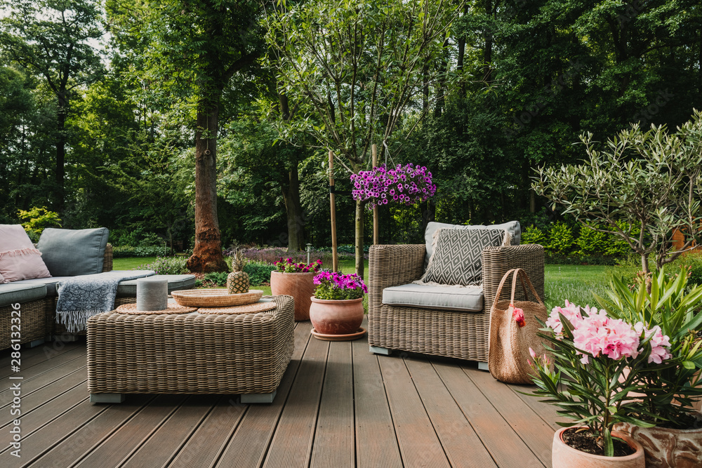 Elegant garden furniture on terrace of suburban home - obrazy, fototapety, plakaty 