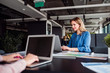 © Halfpoint - Young businesswoman with laptop sitting in an office, working.