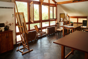 Creative atmosphere in a school of art in a drawing lesson. Solar painting studio, wooden eco design