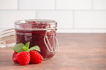 Wall Mural - Jar of Raspberry Jam on a Rustic Wooden Table