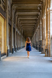 Fototapeta Na drzwi - Blue dress girl in covered passage in the royal palace of Paris
