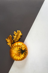 Wall Mural - Autumn composition. Pumpkins, gold color dried leaves on background. Autumn, fall, halloween concept. Flat lay, top view, copy space