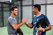 two padel players shaking hands after win a padel match