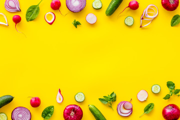 Wall Mural - Sliced, cut, chopped vegetables frame on yellow background top view copyspace