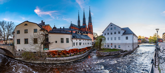 Wall Mural - Sunset view of white building of Uppland museum and cathedral in Uppsala, Sweden